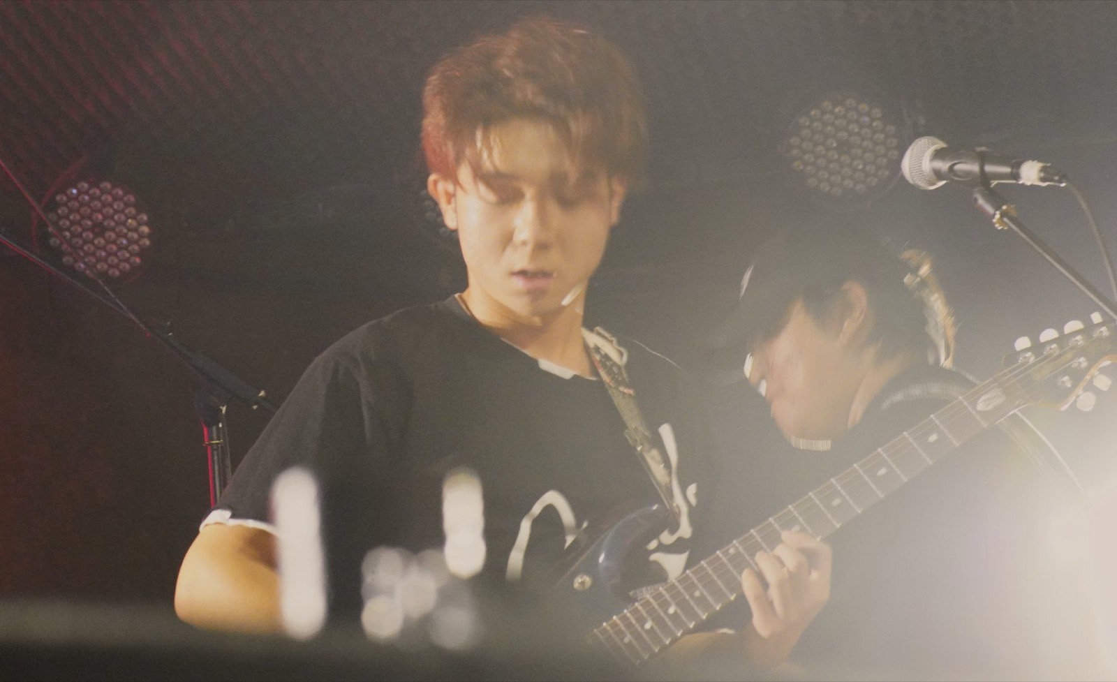 Older guitarist close-up on stage